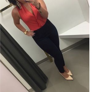 Beautiful Orange Bebe low cut body suit.